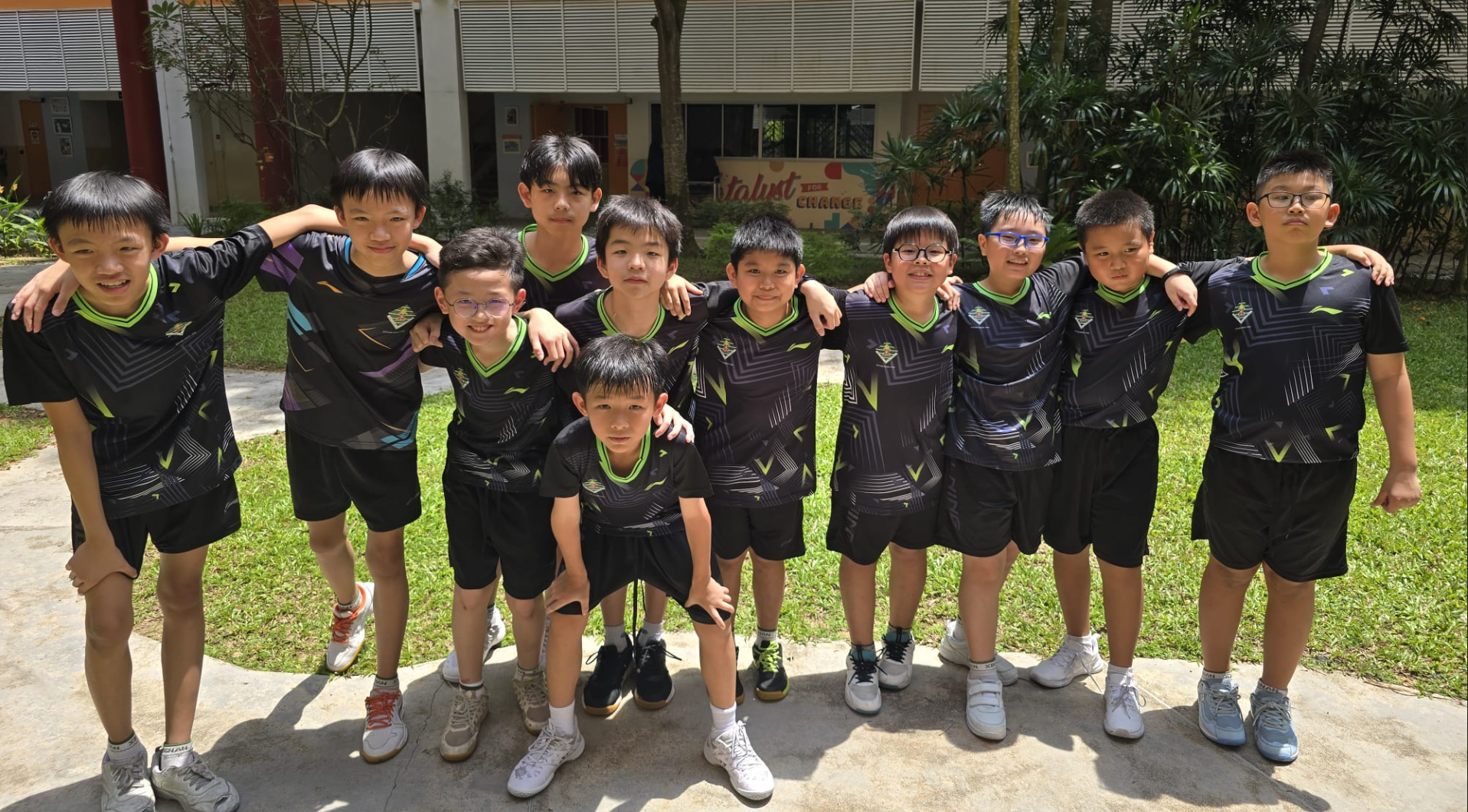 The school badminton boys' team comes together in a display of unity and determination.